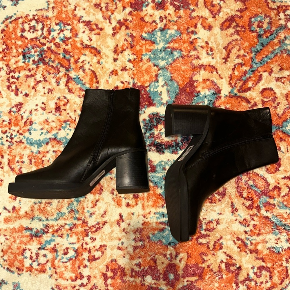 leather black boots with a side ankle zipper closure.